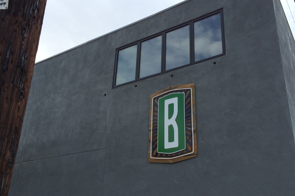 Exterior signage customer logo reclaimed wood with dimesional graphcis applied to surface