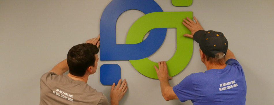 Picture of people installing a sign in a San Diego office