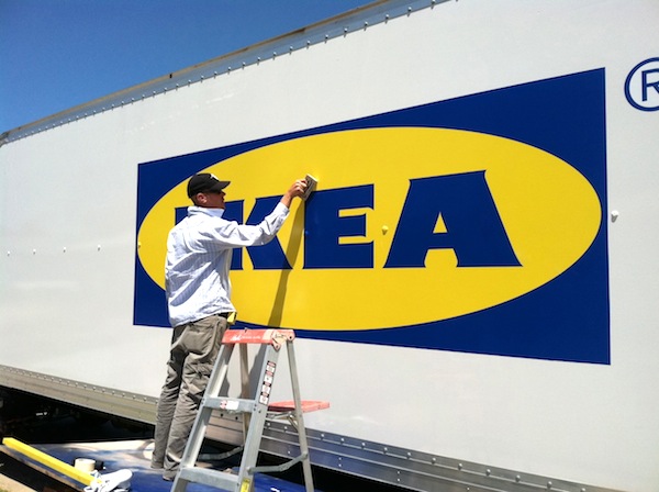 Picture of a large vehicle graphic being installed